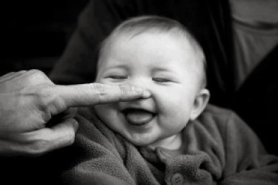 finger touching nose of baby